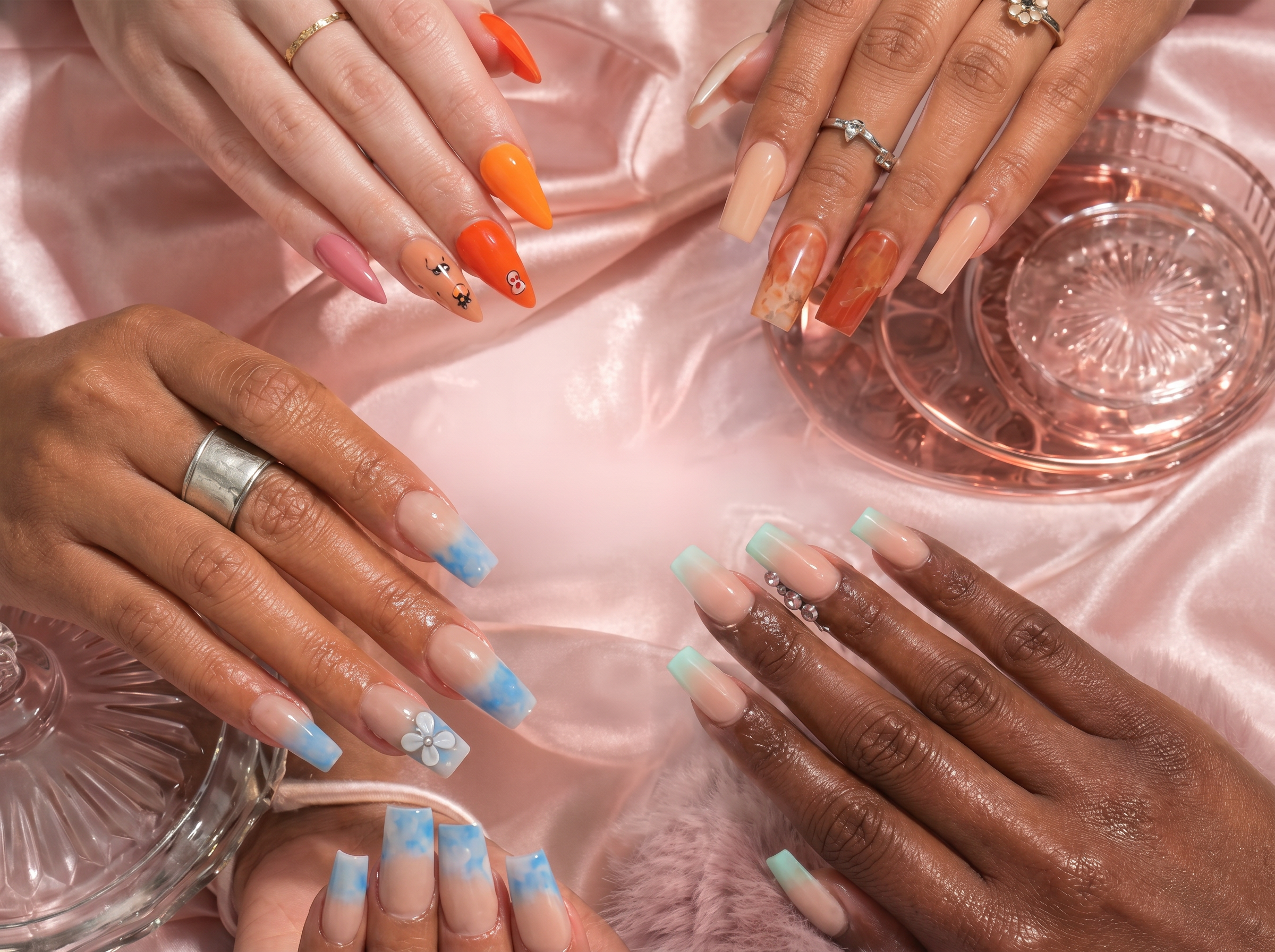 Colorful press-on nail designs on pink satin